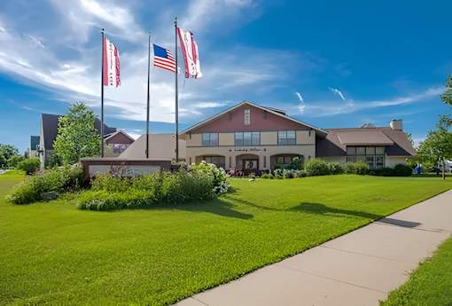 A building with flags in front of it on a sunny day.