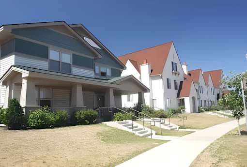 A row of houses with a clear blue sky above them.