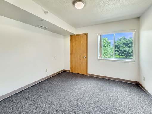 A room with a door and a window.