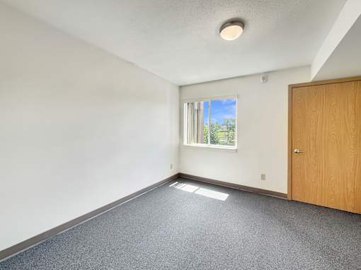 A room with a window and a door.