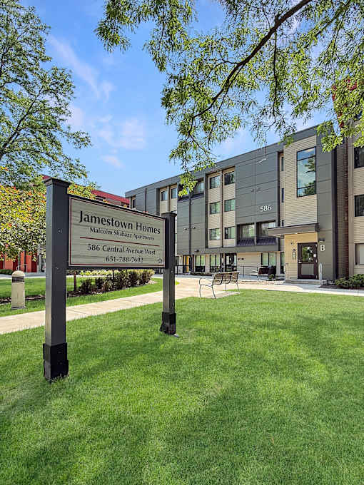 A sign for Jamestown Homes is in front of a building.