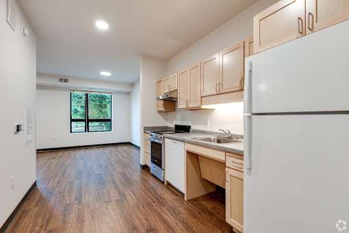 another view of a Stryker Senior Apartments in West St. Paul kitchen with wood flooring and white appliances
