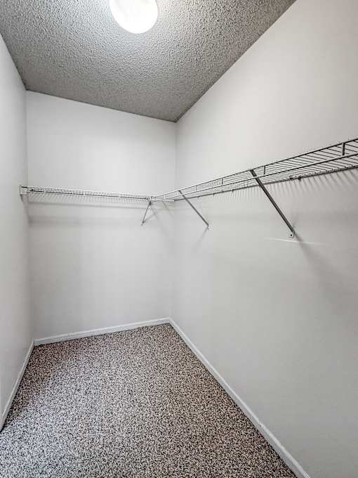 Empty room with a shelf and a light on the ceiling.