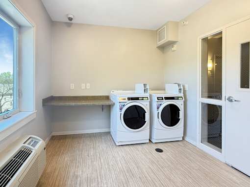 A laundry room with a washer and dryer in it.
