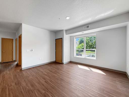 A room with wooden floors and white walls.