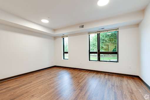 another Stryker Senior Apartments in West St. Paul living room with wood floors and a window