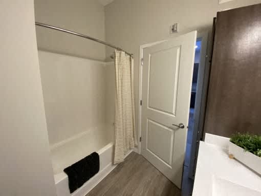 A bathroom with a white door and a white sink.