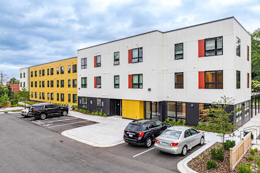 the exterior of Stryker Senior Apartments in west St Paul with cars parked in front of it