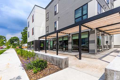 Stryker Senior Apartments with a patio and a sidewalk in front of it