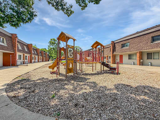 A photo of one of two Liberty Plaza Playgrounds with building in the background