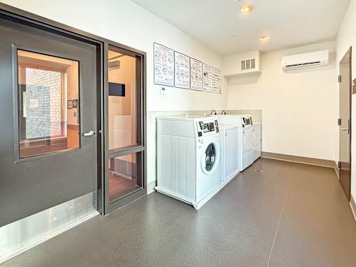 A laundry room with a washer and dryer at The Lumin in the Highland Park neighborhood of St Paul.