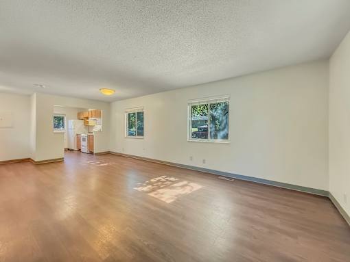 A room with wooden floors and white walls.