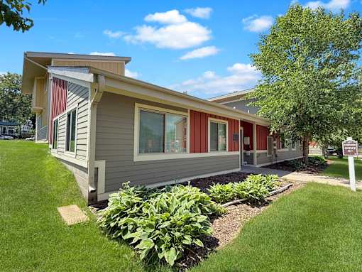 A small house with a red stripe on the side.