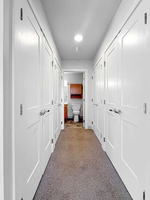 A Closet at Stonehouse Square in Northeast Minneapolis leading to a bathroom