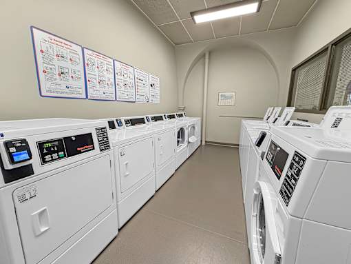A row of washing machines in a laundromat.