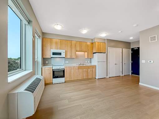 A kitchen with wooden cabinets and a white refrigerator.