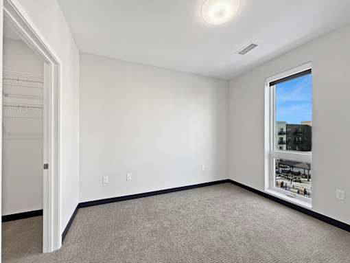 A room with white walls and a carpeted floor.