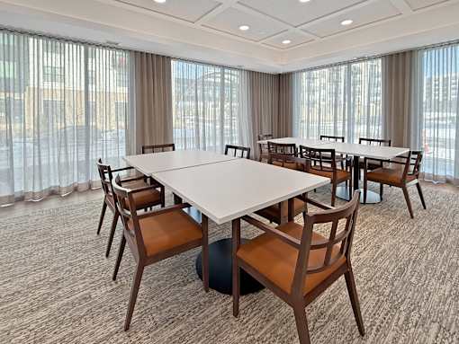 A conference room with a large table and chairs.