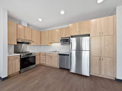 A kitchen with wooden cabinets and stainless steel appliances.