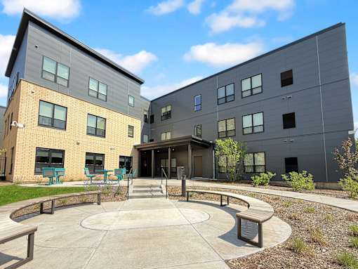 A modern building with a circular courtyard in front.
