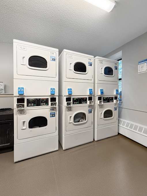 A laundry room with stacked dryers