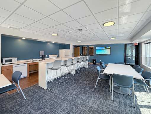 A conference room with a long table and chairs.