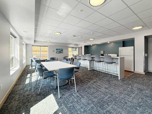 A conference room with a long table and chairs.
