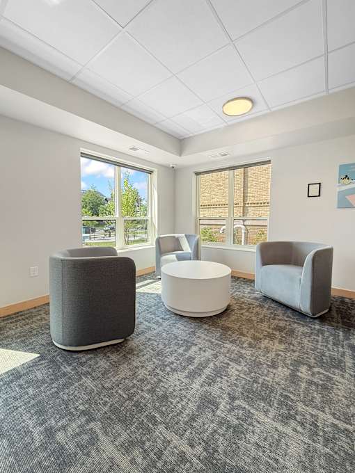 Community Room chairs surround round coffee table