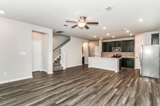 the living room and kitchen in a bedroom plus den unit.