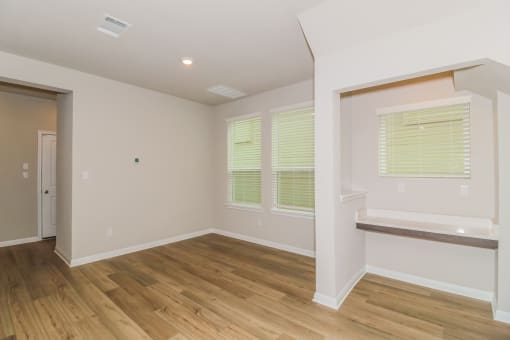 a bedroom with hardwood floors and white walls