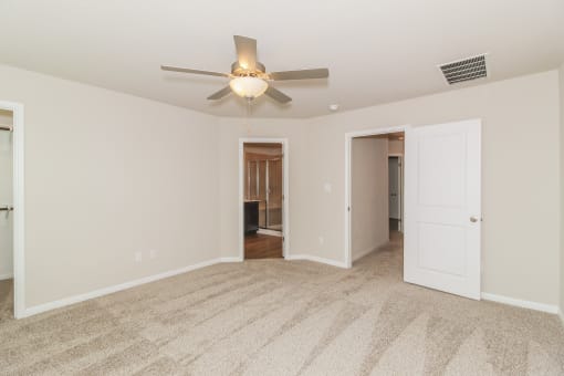a bedroom with a ceiling fan
