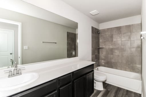a bathroom with a toilet sink and bathtub