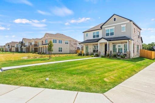 a yard in front of a house with a lawn