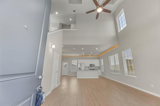 A spacious room with a ceiling fan and a window.