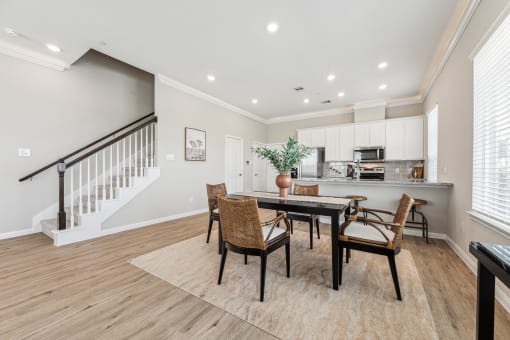 a dining room with a table and chairs
