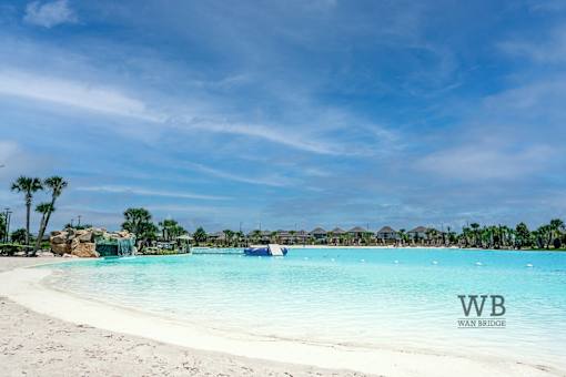 A beautiful beach with clear blue water and white sand.