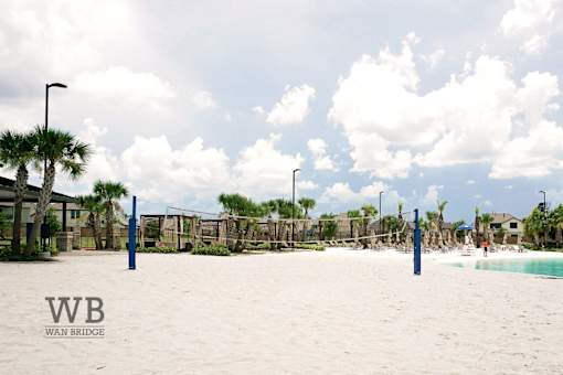 A beach scene with palm trees and a pool.