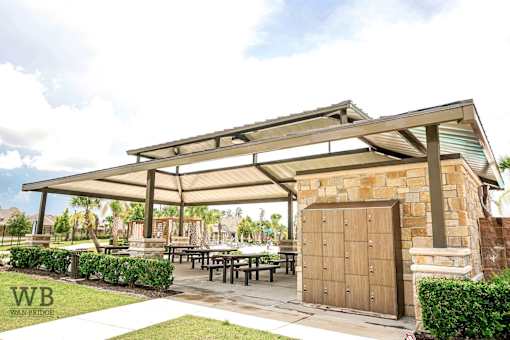 A covered patio area with tables and a wooden door.