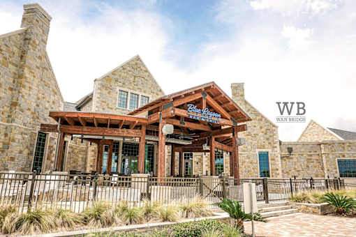 A building with a wooden entrance and a sign that says "WB Wain Bridge".