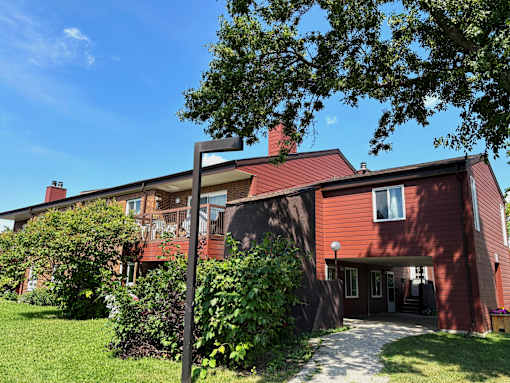 A red house with a white door and windows.