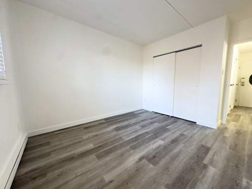 A room with a grey floor and white walls.