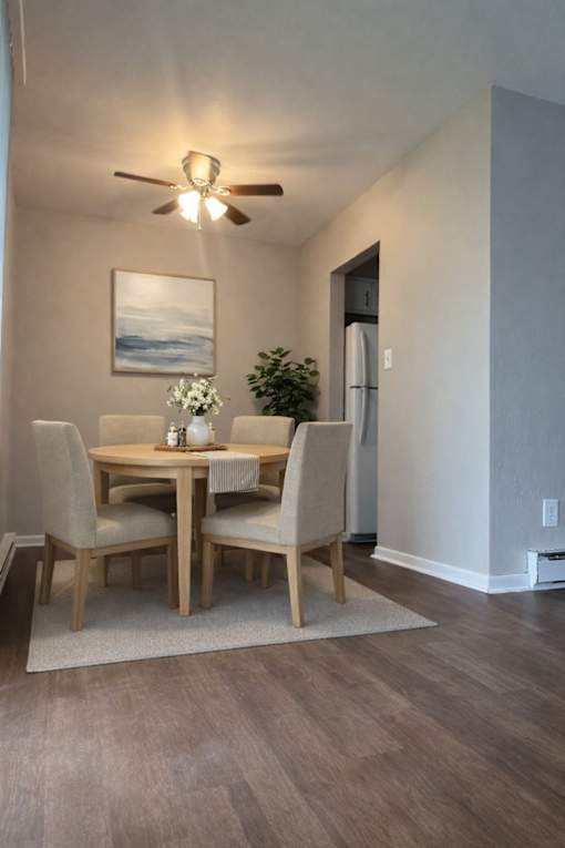A dining room with a table and chairs.