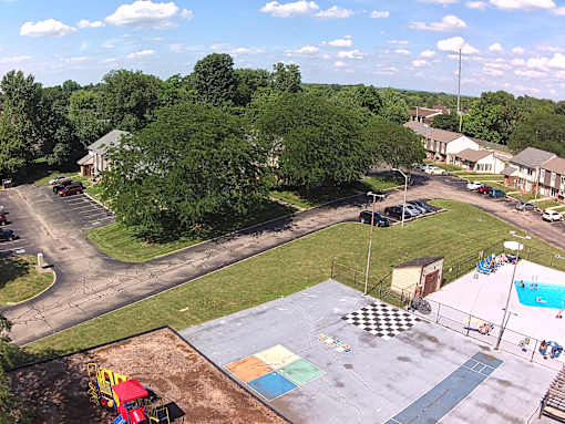 A playground with a slide and a checkered pattern on the ground.