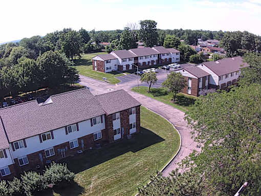 A residential area with houses and greenery.