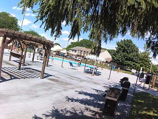 A park with a playground and a pool.