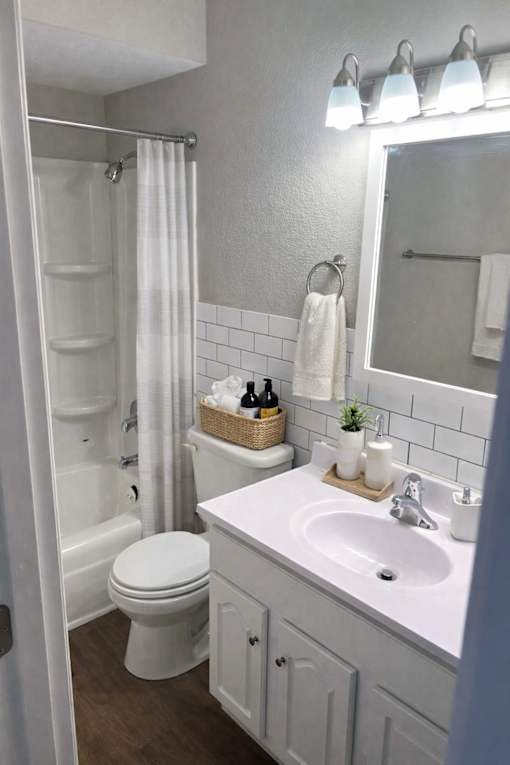 A white toilet is next to a white sink in a bathroom.