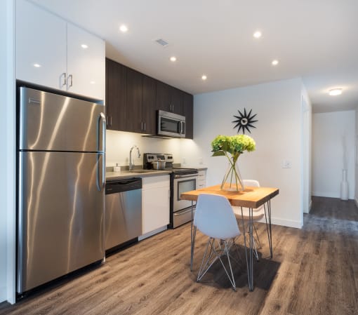 a kitchen and dining area in a 555 waverly unit