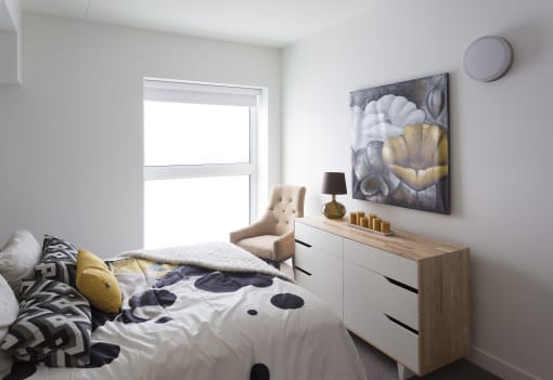 a bedroom with a bed and a dresser