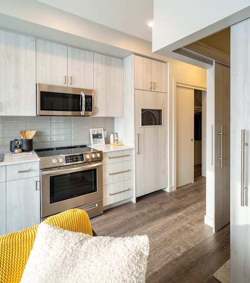 A modern kitchen with a stove, oven, and microwave.