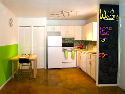 A kitchen with a chalkboard on the wall that says